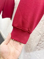 Bright pink sweatshirt cuff with ribbed hem on a hand