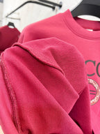 Bright pink sweatshirt sleeve close-up with textured knit fabric