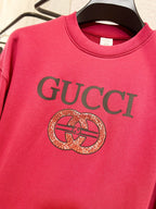 Bright pink Gucci sweatshirt with GUCCI text and circular crest emblem
