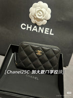Chanel small zip bag with quilted dark exterior and gold CC logo, front view.