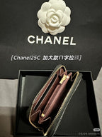 Chanel small bag with dark exterior and burgundy interior, gold chain strap visible.