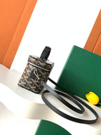 Goyard patterned mini bag with wrist strap and black leather crossbody strap