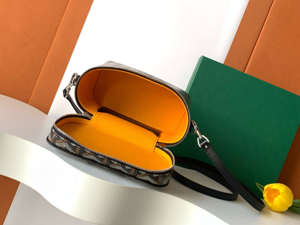 Goyard patterned crossbody bag with orange fabric-lined interior and zipper