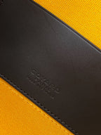 Embossed Goyard leather interior panel on black-and-orange bag