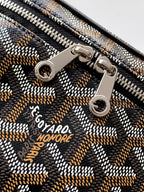 Goyard patterned zipper pull detail with engraved logo and metal rings