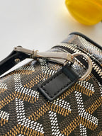 Goyard patterned bag with metal clasp and black leather wrist strap