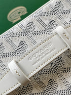 Goyard patterned mini bag closeup of leather strap with embossed logo