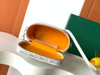 Goyard mini bag with zip top opened to reveal orange lining