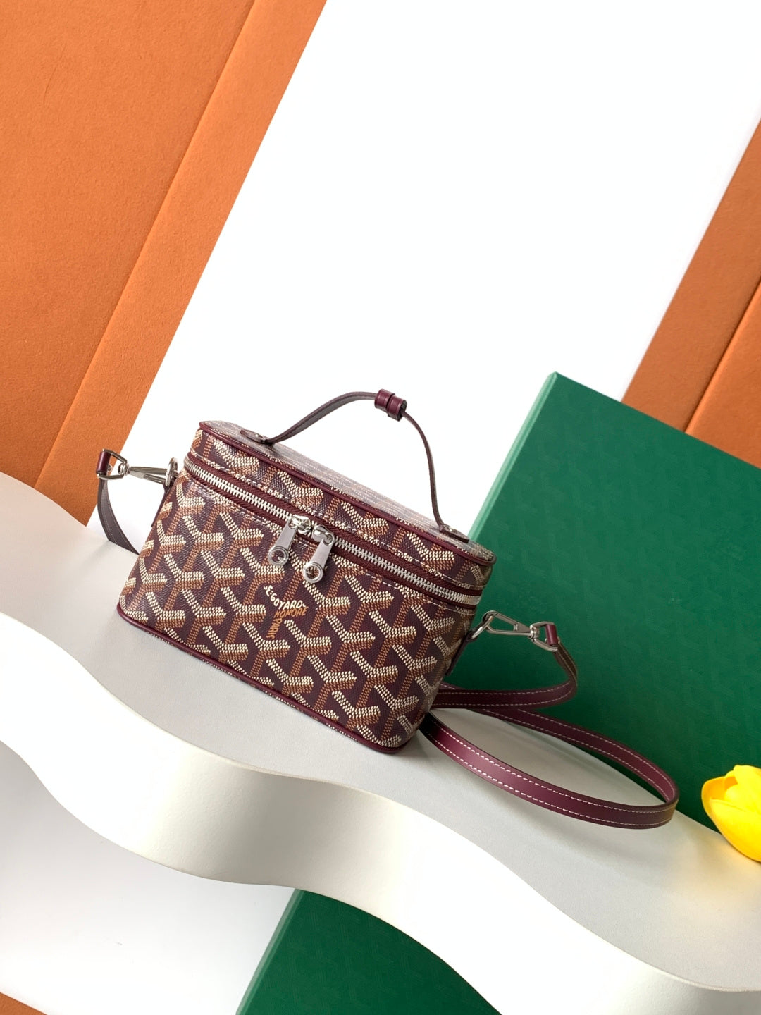 Goyard patterned crossbody bag with burgundy leather trim and adjustable strap