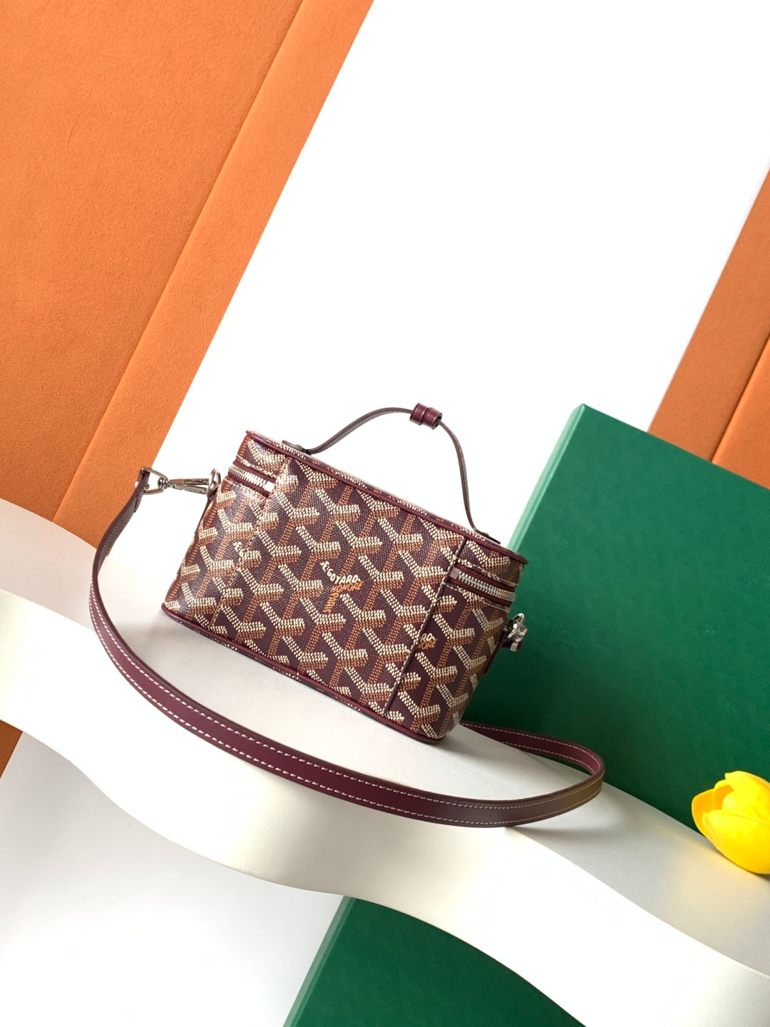 Goyard small crossbody bag with burgundy strap, top zip, front logo detail
