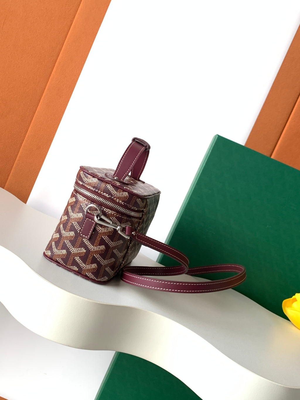 Goyard mini crossbody bag with top handle, burgundy strap, monogram canvas