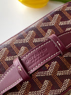 Goyard burgundy leather strap tab with embossed logo on patterned bag