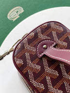 Goyard rounded crossbody bag with burgundy leather strap and monogram canvas