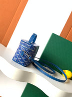 Goyard blue patterned mini bag with short handle, long strap, and zipper closure