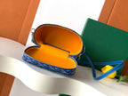 Goyard blue patterned mini bag with orange fabric interior and open zipper