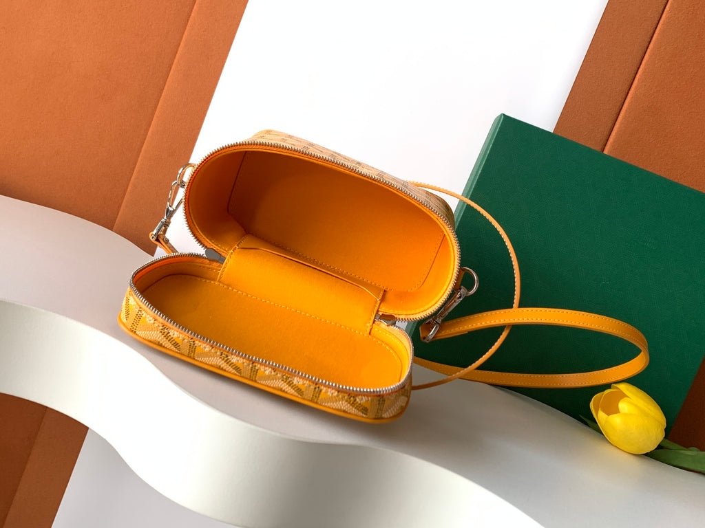 Yellow mini bag with strap, open top showing orange fabric lining