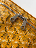 Yellow monogram bag zipper with metal pulls and snap hardware