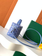 Blue patterned crossbody bag with top handle and shoulder strap