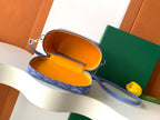 Blue patterned crossbody bag with open zipper and orange interior lining