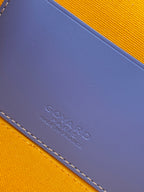Blue leather patch with embossed mark on crossbody bag