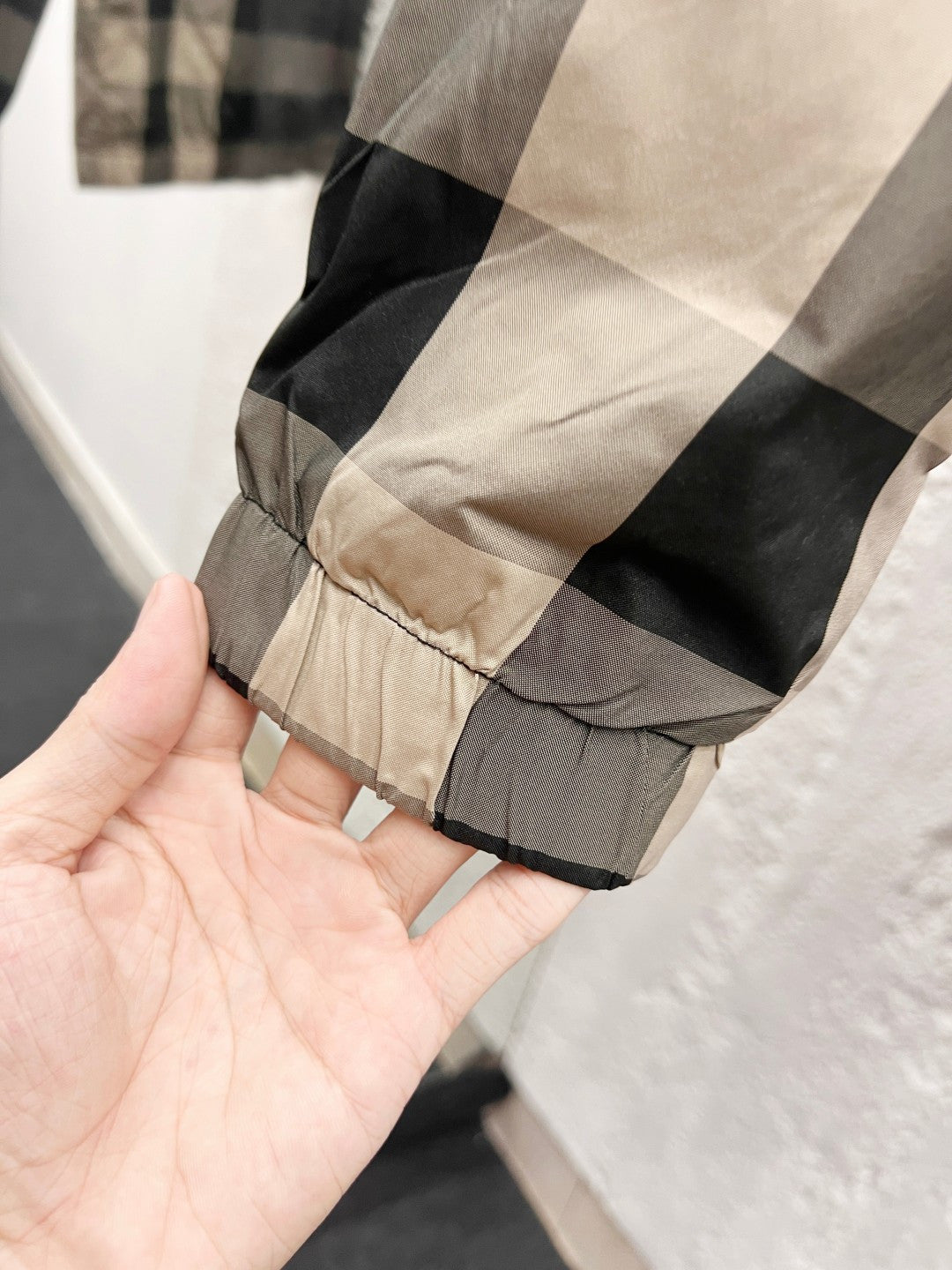 Burberry jacket hem with gathered elastic and check fabric cuff, dark gray