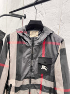 Burberry hooded jacket front with check pattern, zipper, and horse logo pocket patch