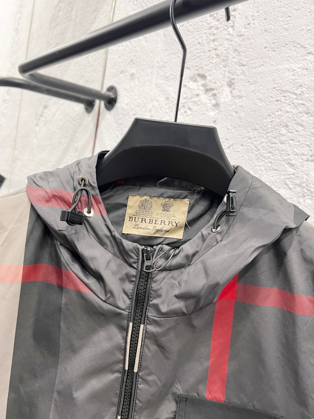 Burberry hooded jacket collar close-up with inner label and black zipper pull