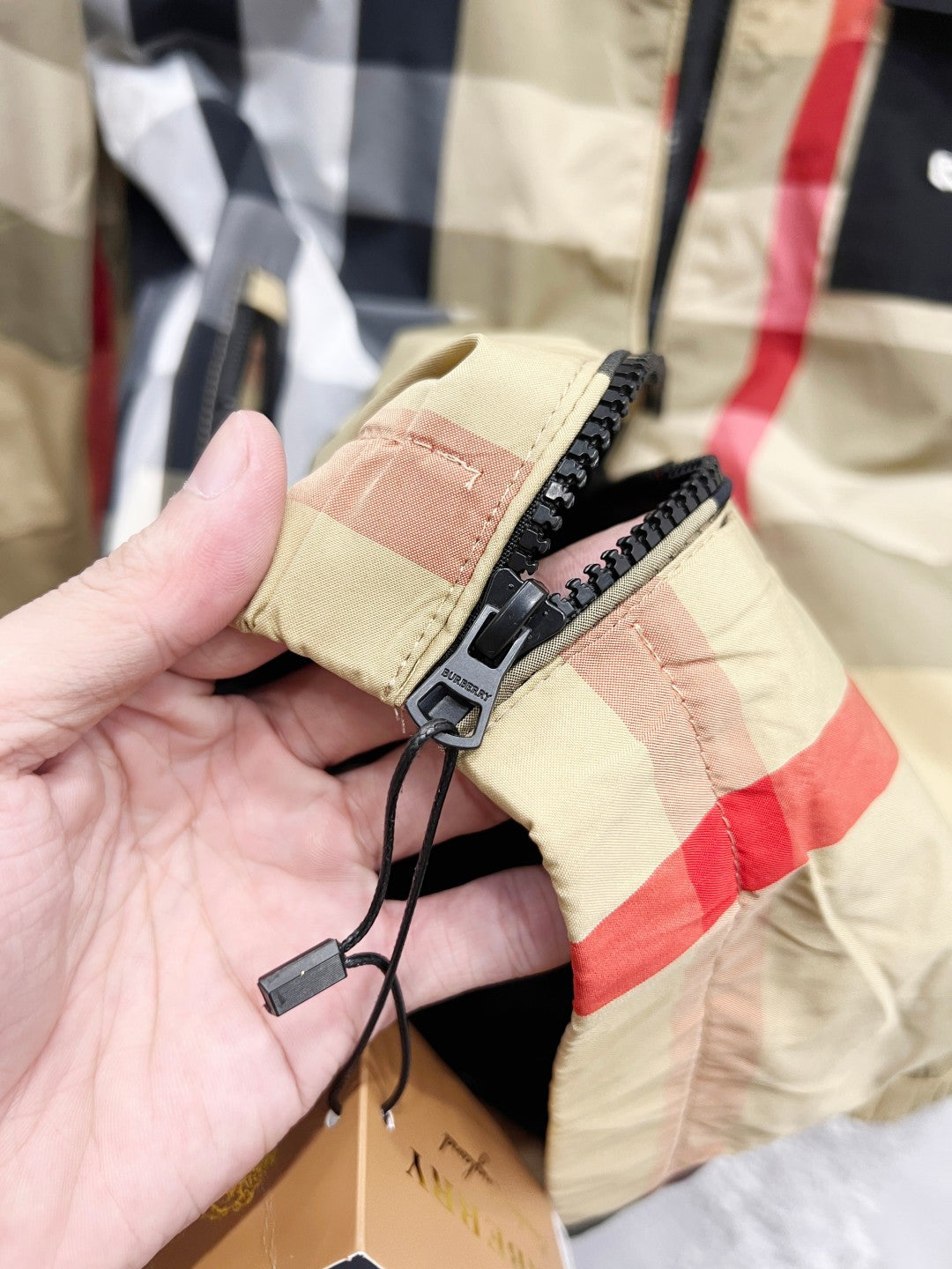Burberry check hooded jacket sleeve cuff with adjustable drawcord and zipper tab