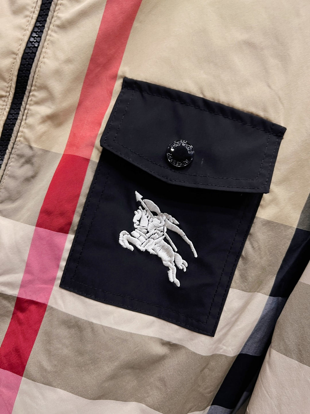 Burberry check hooded jacket chest pocket with embossed button and white emblem