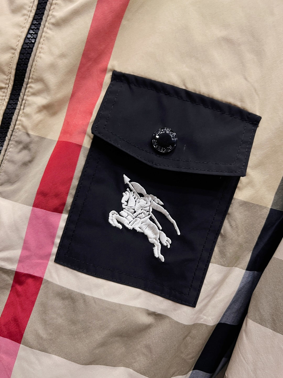 Burberry check hooded jacket chest pocket with embossed button and white emblem