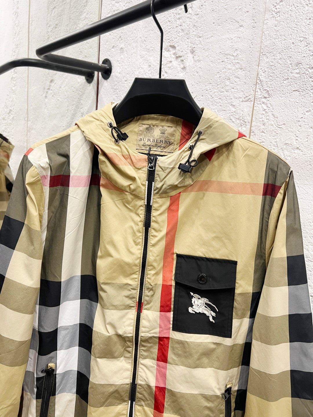 Burberry check hooded jacket on hanger, front zipper and chest logo pocket