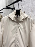 White hooded jacket front with stand collar, full zipper, and small chest logo