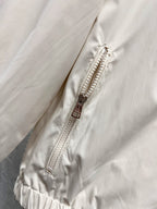 White jacket with exposed front zipper and stitched placket close-up