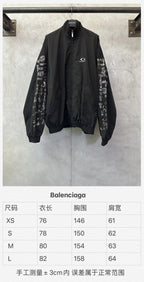 Long black bomber jacket with printed sleeve panels and front zip