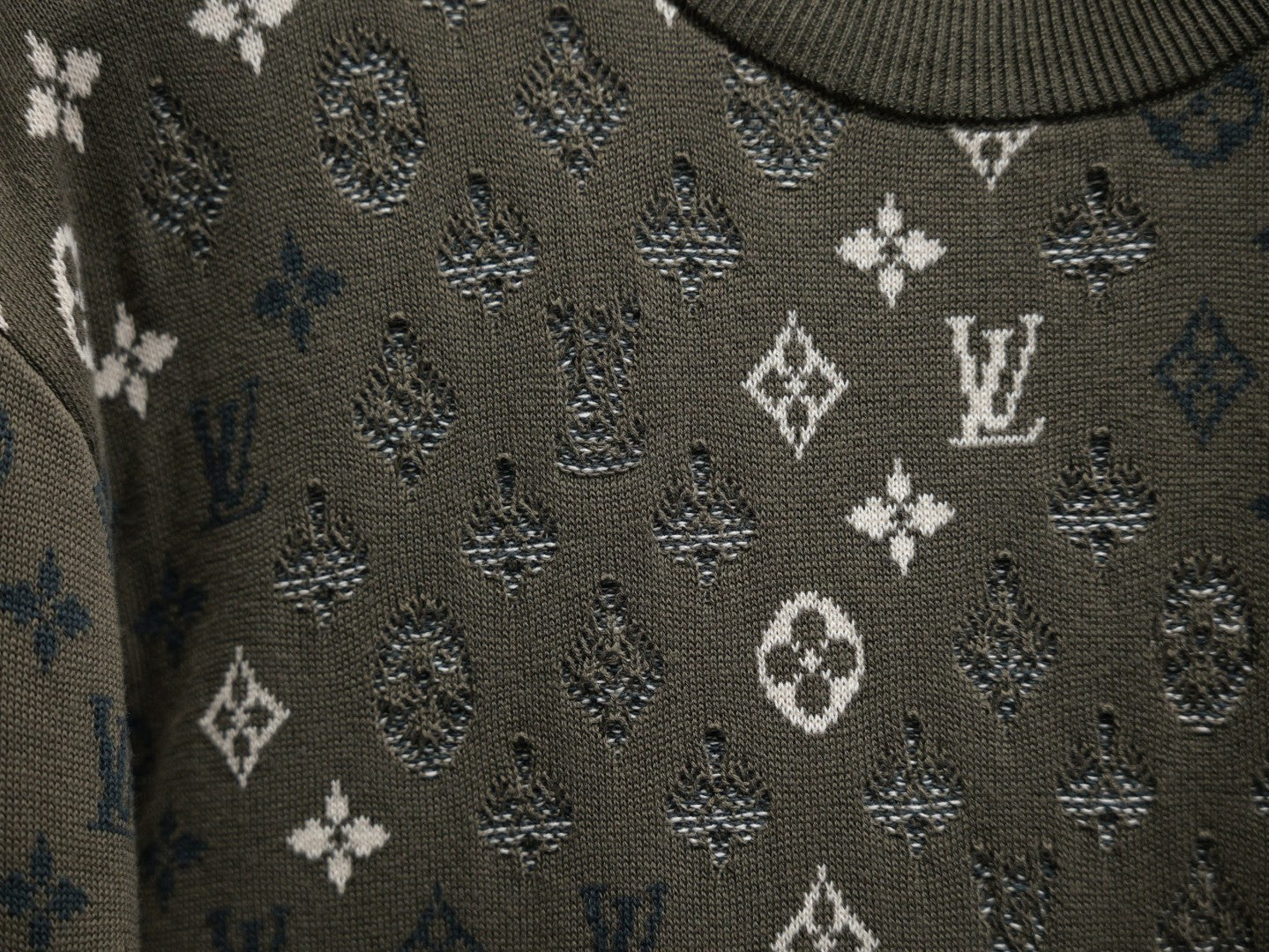 Louis Vuitton monogram sweatshirt knit close-up, textured dark olive with white motif pattern