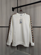 Burberry kids crewneck sweatshirt, cream with check trim sleeves and small chest graphics.
