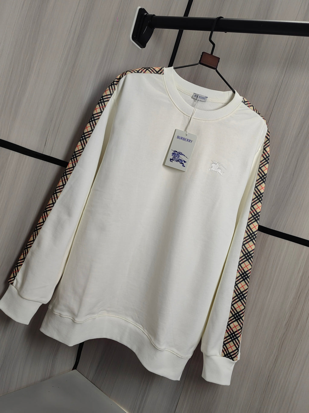 Burberry kids crewneck sweatshirt in cream with check-trim sleeves and front chest motifs.
