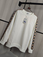 Burberry kids crewneck sweatshirt in cream with check-trim sleeves and front chest motifs.