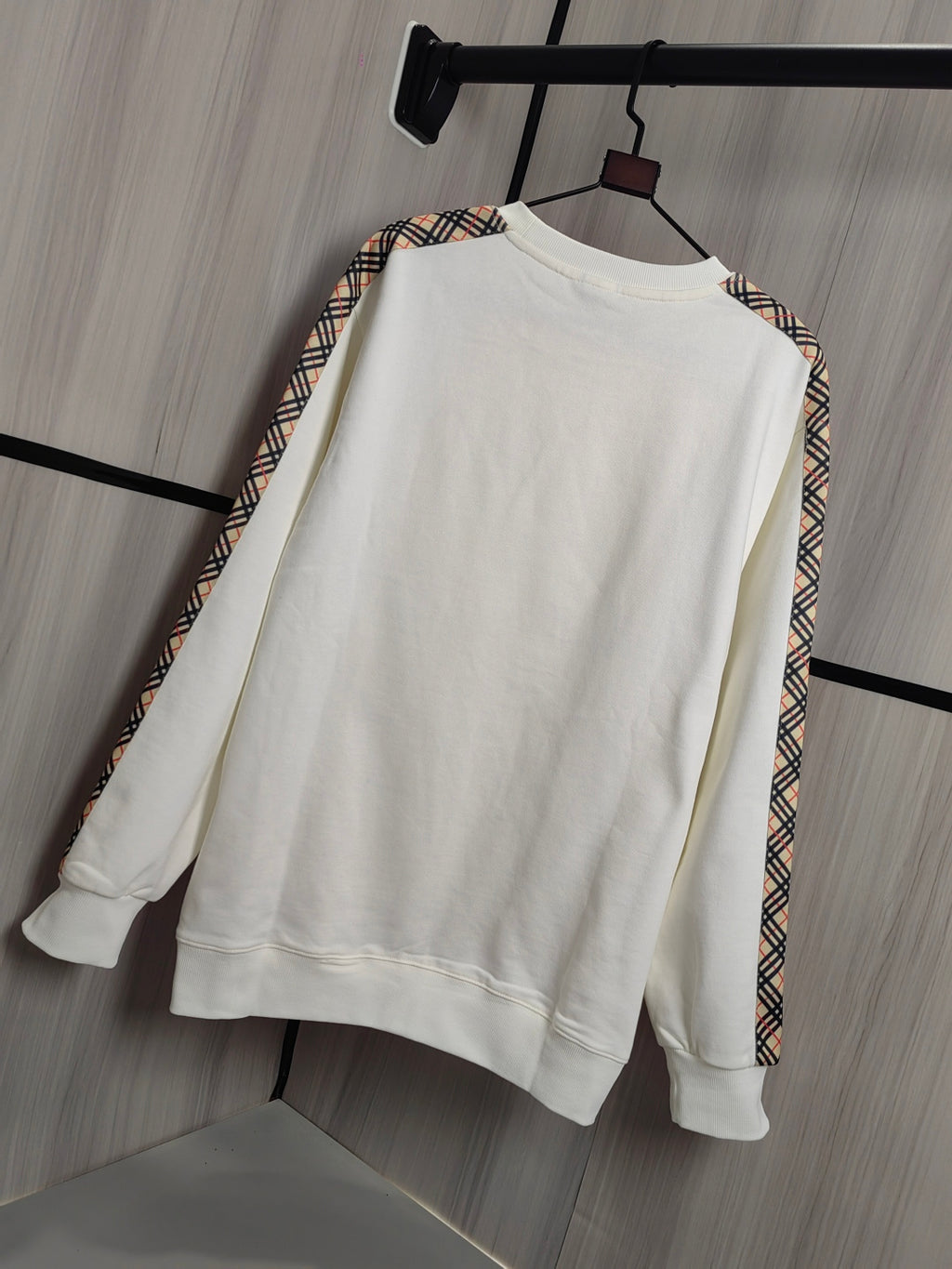 Burberry kids crewneck sweatshirt, cream front view with check-trim detail on sleeves.
