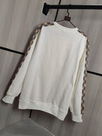Burberry kids crewneck sweatshirt, cream front view with check-trim detail on sleeves.