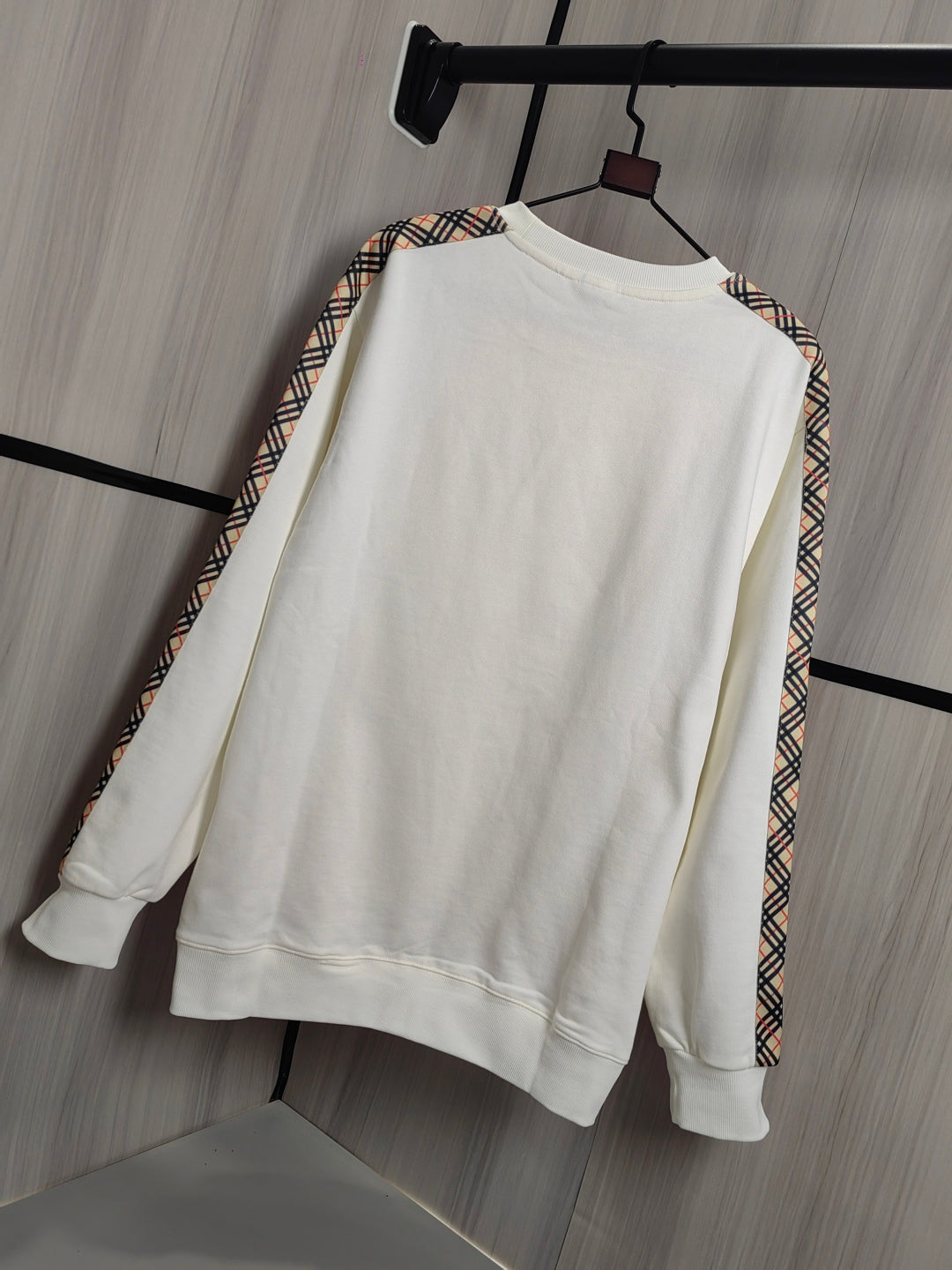 Burberry kids crewneck sweatshirt, cream front view with check-trim detail on sleeves.