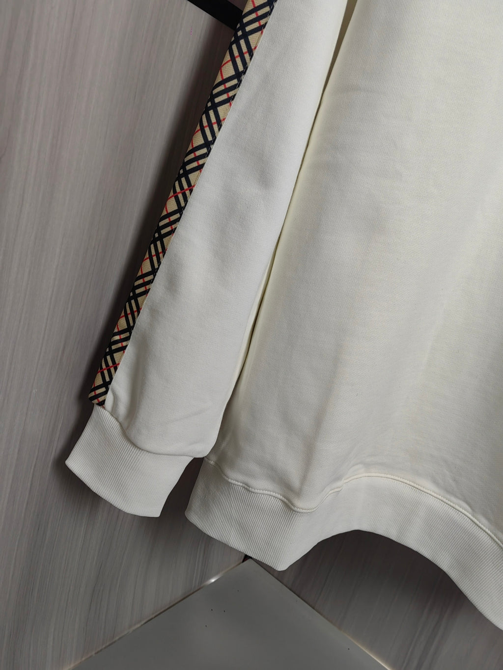 Burberry kids crewneck sweatshirt back view in cream with check-trim accents at side.