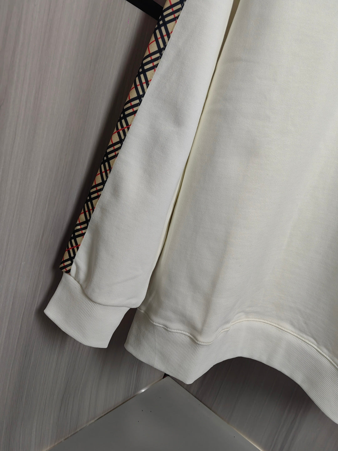 Burberry kids crewneck sweatshirt back view in cream with check-trim accents at side.