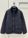 Dark quilted jacket with stand collar, snap button front, and patch pockets