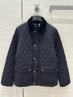 Dark quilted jacket with stand collar, snap button front, and patch pockets