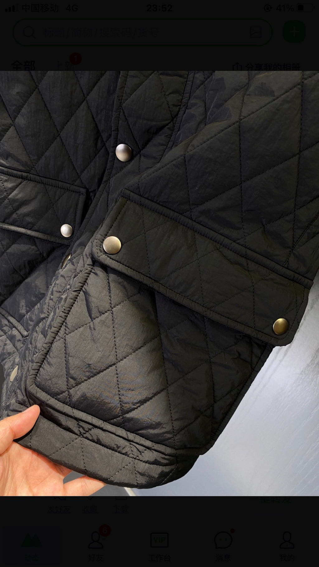 Quilted jacket sleeve close-up with snap buttons and stitched panel details