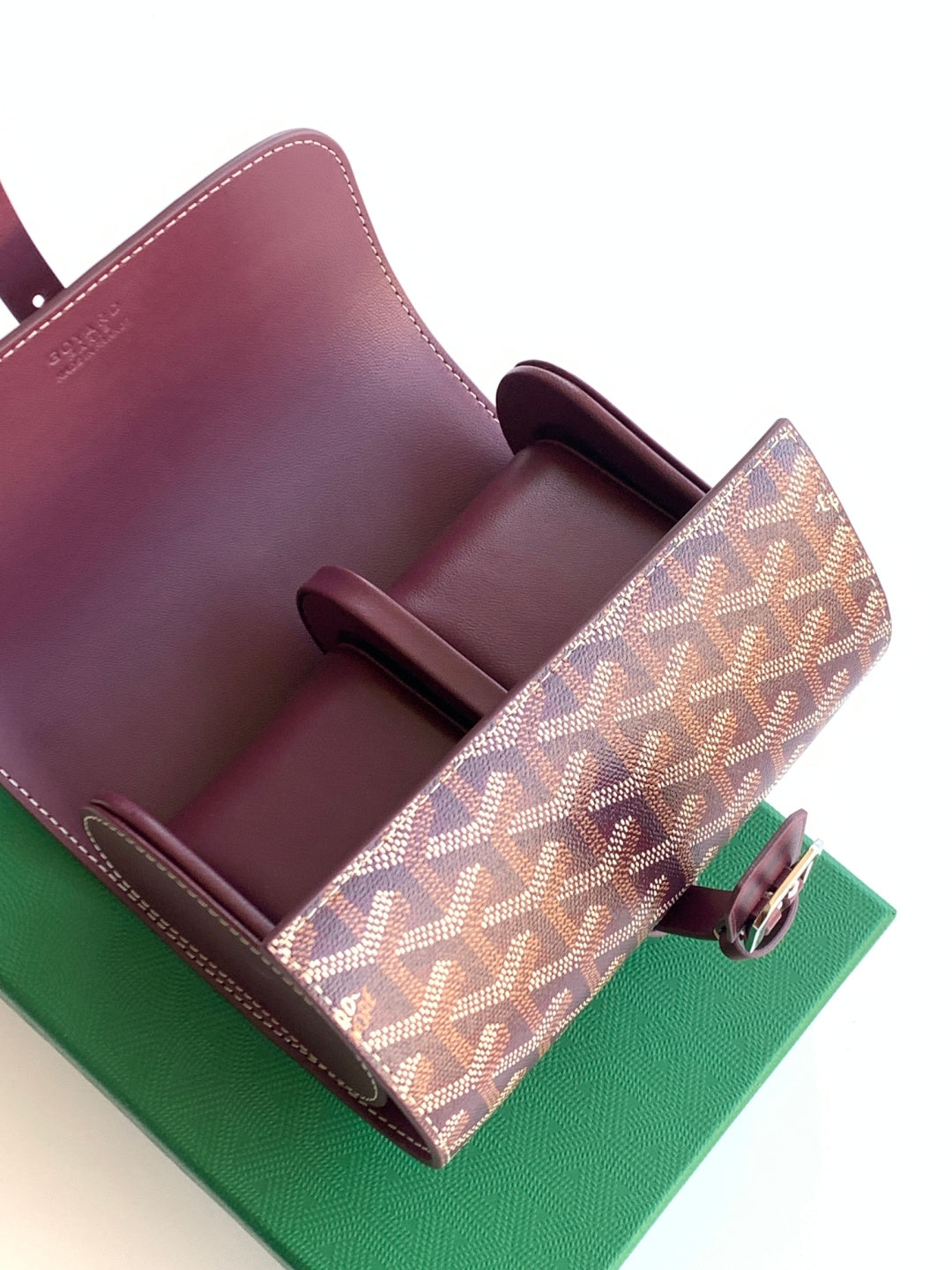 Goyard monogram bag open with burgundy leather interior dividers