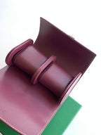 Goyard bag interior with burgundy lining and rounded card slots
