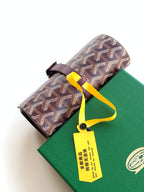 Goyard monogram roll-top bag with burgundy strap and yellow tie