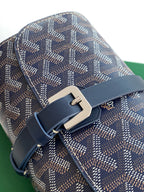 Goyard monogram bag with navy leather buckle strap and metal clasp